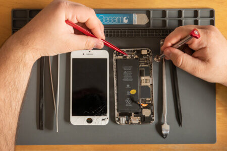 iPhone With Tools And Hands