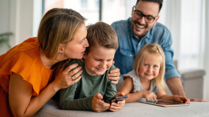 Happy Family Spending Time At Home And Using Digital Devices Together. Technology People Fun Concept.