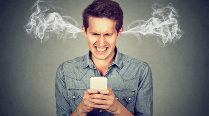 Frustrated Angry Man Reading A Text Message On His Smartphone Blowing Steam Coming Out Of Ears