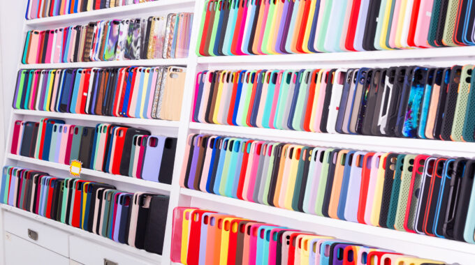 Different Mobile Phone Cases On Shelves In A Multimedia Store