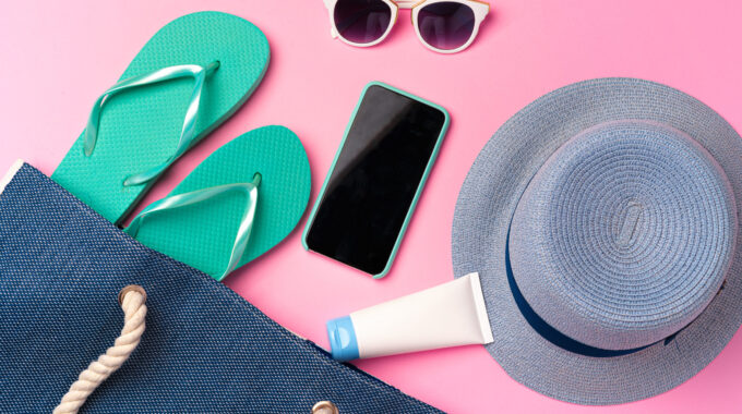 Beach Bag, Flip-flops And Hat On Pink Background With Smartphone And Sunglasses. Summer Concept